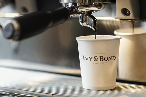 The IVY & BOND Logo Design on a Coffee Cup